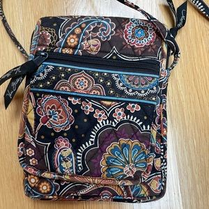 Vera Bradley crossbody bag with many pockets in brown paisley pattern.